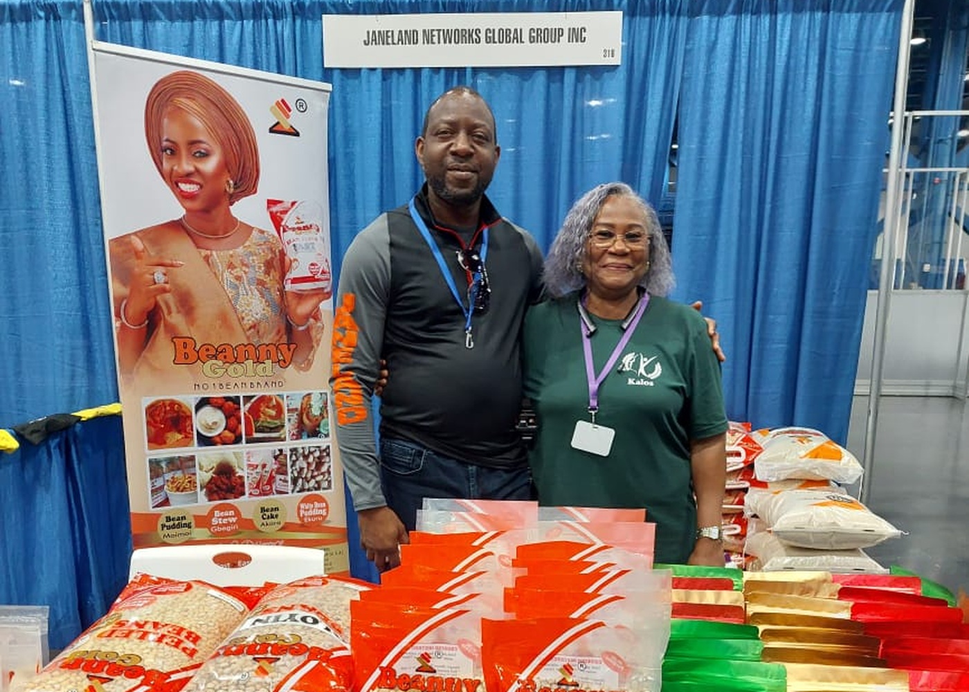 Janeland Networks Global Group team at their BeannyGold trade-show booth with packaged bean products